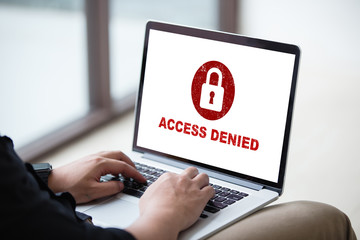 Protection security system concept. Man working on laptop with access denied text on screen.