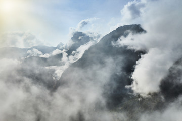 Scenic view of misty mountains above Halstatt village in Austria.