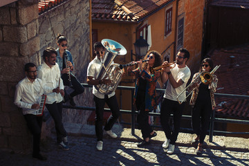 Fototapeta premium Jazz band a group of musicians with wind instruments playing on the street of the city.
