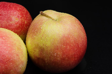 wet apples on a black background