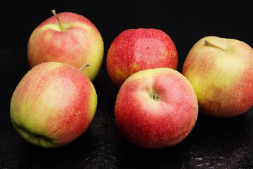 wet apples on a black background