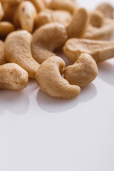 cashew nuts on a white acrylic background