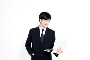 Asian business handsome man has holding laptop for woking with happy and relaxing isolated on white background.