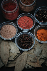 spices in containers on a black background