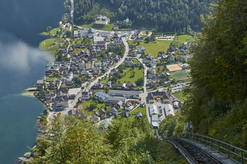 Fototapeta premium View of a funicular rail leading to a skywalk view in Austria with hallstatt village in the background.