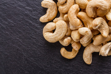 cashew nuts on a dark stone background