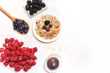 bowl of corn flakes with berries on white background.