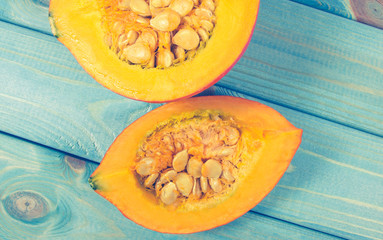 Pumpkins on rustic blue background. Autumn background.