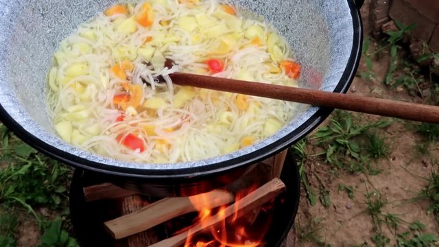 A stew cooked in cauldron over fire