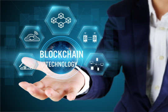 Businessman holding blockchain icon on virtual screen,Blockchain technology concept,Elements of this image furnished by NASA.