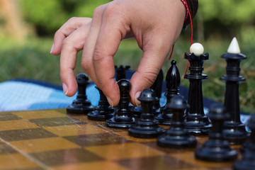 first step concept of human hand on black chess pawn figure