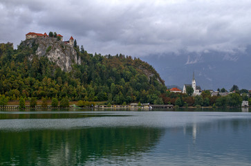Fototapeta na wymiar Medieval castle Bled on Lake Bled in Slovenia is the oldest medieval town in Slovenia . Mountains in background. Slovenia, Europe. European travel.