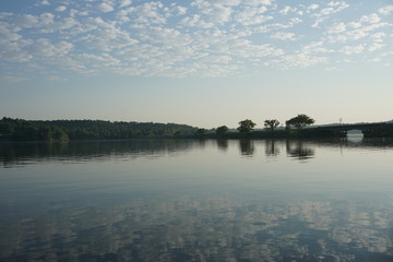 clouds reflecting on lake water in early morning