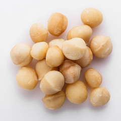 delicious macadamia nuts on a white acrylic background