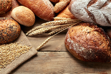 assortment of baked bread on wooden table