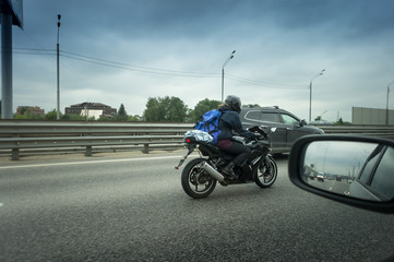 Obraz na płótnie Canvas young man riding sport motorcycle on the highway with metal safety barrier or rail