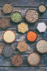 Gluten-free concept. Grains, cereals and seeds for baking. Millet, quinoa, corn, buckwheat, rice, amaranth, chickpea, coconut, chia, soy, oats, lentils. Healthy food. Top view.