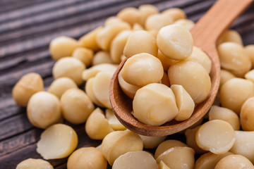 delicious macadamia nuts on a wooden rustic background