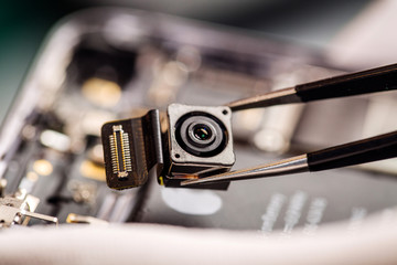 Repairing Damaged Smart Phone in service center. closeup