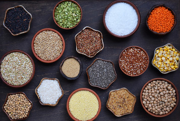 Gluten-free concept. Grains, cereals and seeds for baking. Millet, quinoa, corn, buckwheat, rice, amaranth, chickpea, coconut, chia, soy, oats, lentils. Healthy food. Top view.