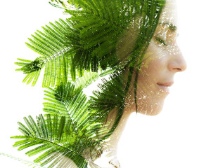 Double exposure profile portrait of a naturally beautiful woman with closed eyes and bright green...