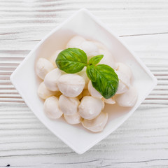 Mozzarella tomatoes and basil on a wooden rustic background