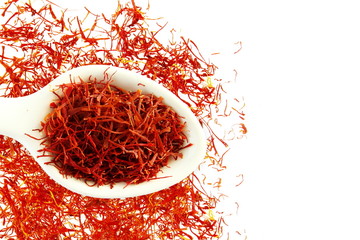saffron in spoon on white background for food and flavor extract concept,flat lay