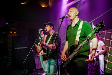 Band performs on stage in a nightclub