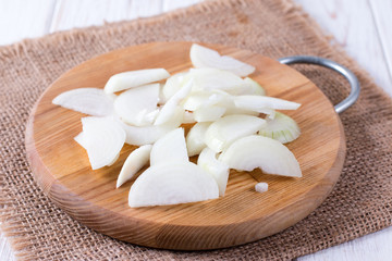 Sliced onion on a cutting board on a table