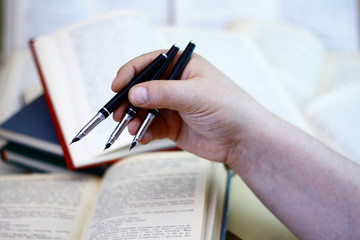 Three black pen in hand.