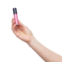 Female hand holding pink matt lipstick on white