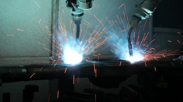Welding robots movement in a car factory, automotive parts industry