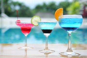 summer alcoholic drinks and cocktails at poolside bar