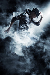 Fototapeta premium Man break dancing on smoke background