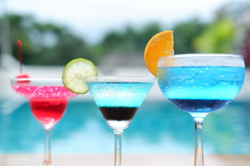 summer alcoholic drinks and cocktails at poolside bar