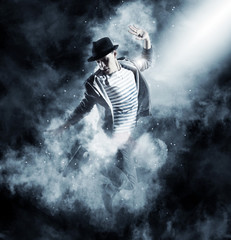 Fototapeta premium Man break dancing on smoke background