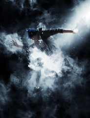Man break dancing on smoke background
