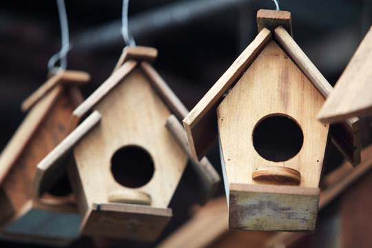 close up of hanging small wooden bird house