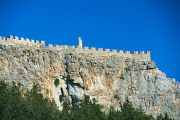 Medieval walls and antique columns on the top of the rock in the city of Lindos.