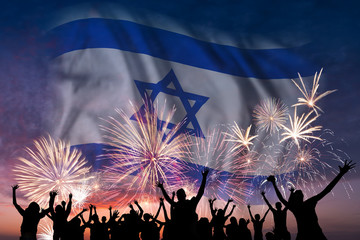 People are looking on fireworks and flag of Israel