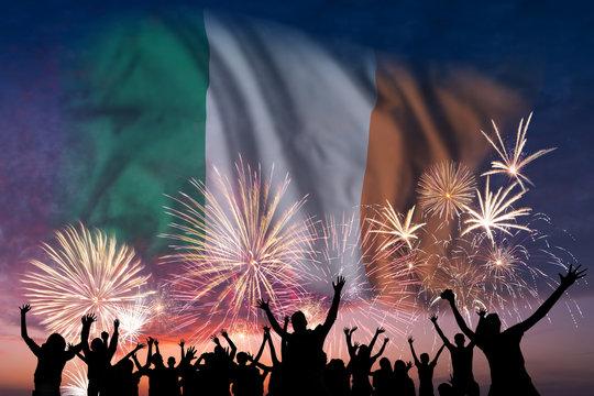 People are looking on fireworks and flag of Ireland - Powered by Adobe