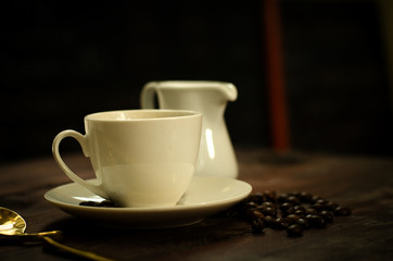 Coffee beans, glass and equipment for drinking coffee with warm light
