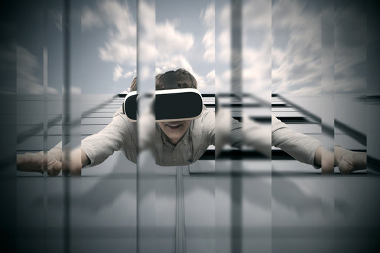 Man wearing virtual reality glasses flying from a skyscraper
