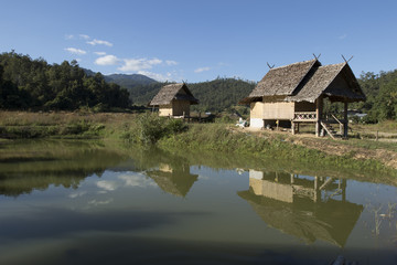 Fototapeta na wymiar Houses on stilts by Bamboo Bridge, Pai