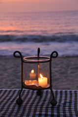 Fototapeta na wymiar Burning candle on the sunset