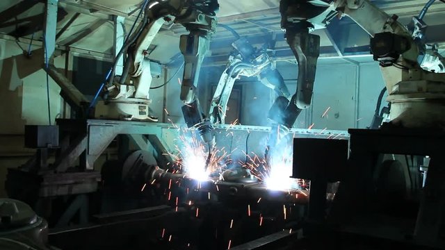 Welding robots movement in a car factory, automotive parts industry