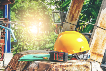 Yellow helmets,document file, radio communication placed on the Excavator