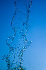 Fototapeta na wymiar transparent falling water vertical flows, close up