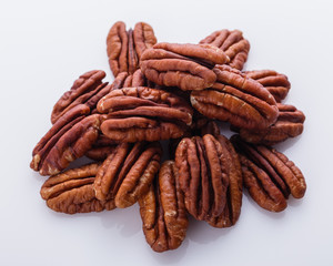 delicious pecan nuts on a white acrylic background