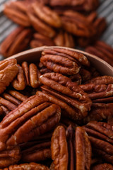 delicious pecan nuts on a rustic wooden background
